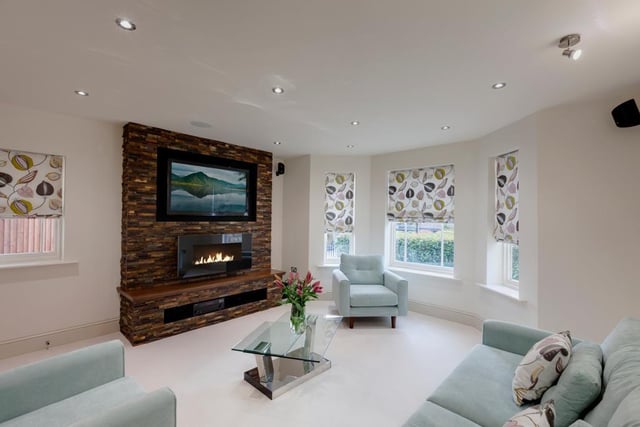 The focal point of the lounge is the feature wall with split face tiles, provision for a wall mounted television, timber shelf and a contemporary gas fire.