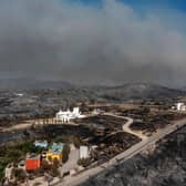 Tens of thousands of people have already fled blazes on the island of Rhodes, with many frightened tourists scrambling to get home (Picture: Spyros Bakalis/AFP/Getty Images)