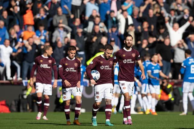Hearts players look dejected as Rangers celebrate the opening goal on Saturday.