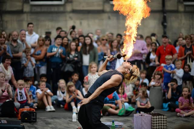 A street entertainer performs on Edinburgh's Royal Mile during the city's Festival Fringe