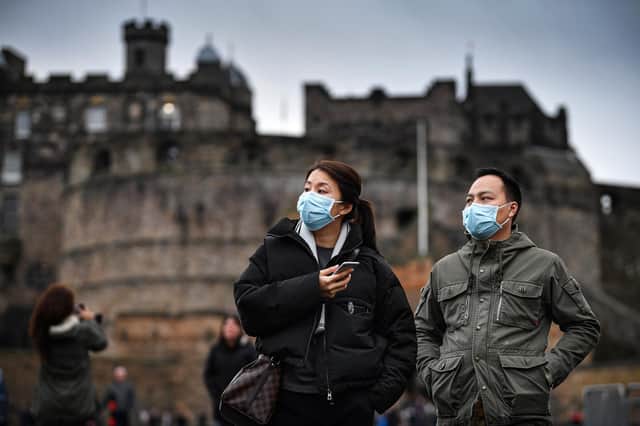 Tourists wearing face masks visit Edinburgh Castle in January last year (Picture: Jeff J Mitchell/Getty Images)
