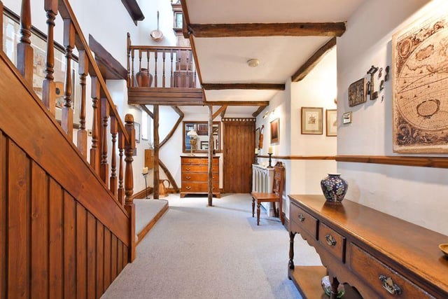 The reception hall has a galleried landing with exposed beams and timbers, complemented by feature windows.