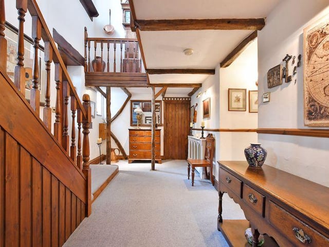 The reception hall has a galleried landing with exposed beams and timbers, complemented by feature windows.