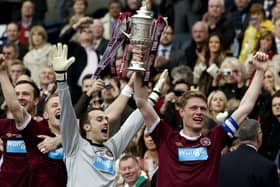 Captain Marius Zaliukas, right, holds up the Scottish Cup trophy after Hearts defeated Hibs in the 2012