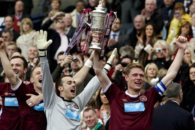 Captain Marius Zaliukas, right, holds up the Scottish Cup trophy after Hearts defeated Hibs in the 2012 final. Picture: SNS