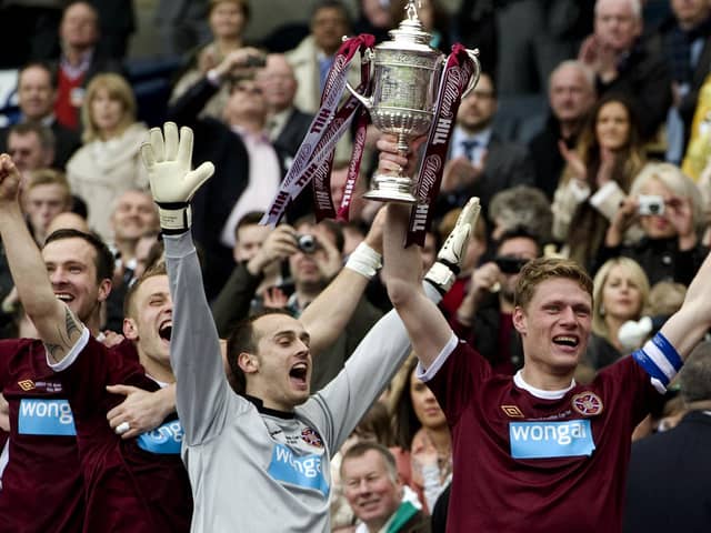 Captain Marius Zaliukas, right, holds up the Scottish Cup trophy after Hearts defeated Hibs in the 2012