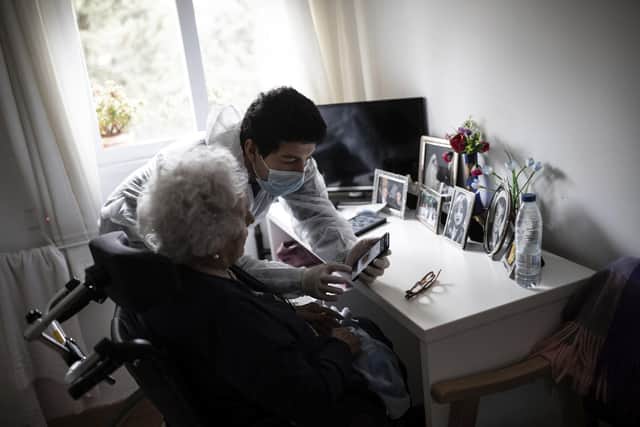 Stock image. A care home worker helps an elder resident