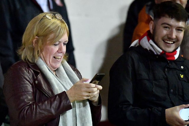 A Sunderland fan checks her phone during the Crewe game.