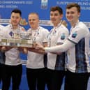 Scotland´s team (from left) coach Michael Goodfellow, Kyle Weddall, Hammy McMillan, Bobby Lammie,Grant Hardie and Bruce Mouat pose with their gold medals after their victory in the men's gold medal at the European Curling Championships. Picture: Mats Andersson/Getty