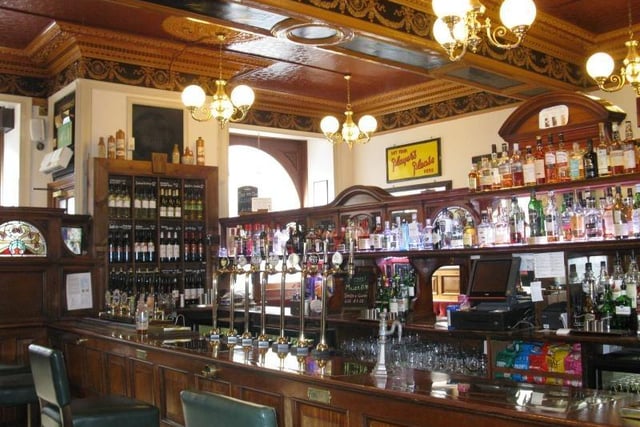 CAMRA says: A magnificent island-bar pub built in 1899 in a four-storey sandstone tenement by P L Henderson. It is well worth going out of your way to visit. It is unique, having a
gantry-like structure on the top left-hand side of the bar counter and a series of low, ticket booth-like windows for service, which are numbered on the inside.