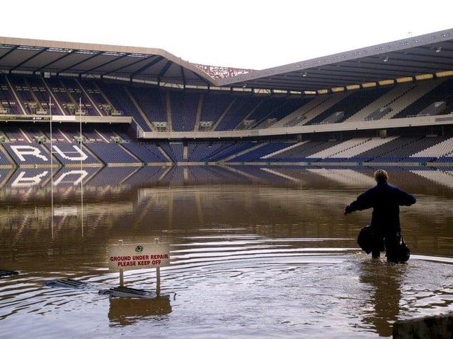 Following heavy rainfall in April 2000, Murrayfield Stadium was flooded. Here you can see the head groundsperson Heath MacKinnon as she wades through the water.