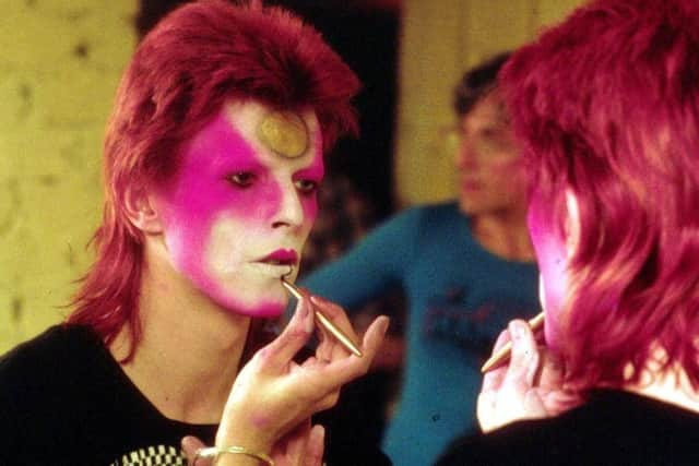 David Bowie applying his Ziggy Stardust makeup in the 1970s. Picture: R Bamber/Rex Features
