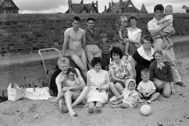 A group of visitors on the beach at Leven, Fife, in summer 1961.