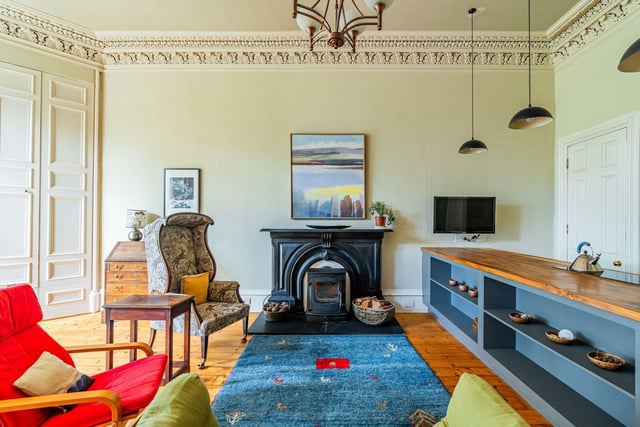 The airy open-plan lounge/kitchen/diner with wood burning stove, wall-to-wall fitted book shelves, stunning cornice and picturesque views over Bruntsfield Links from the bay window.