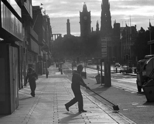 Early morning in Princes Street Edinburgh, August 1987. Men from the cleansing department sweep the pavement before a busy day.
