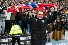 Elias Melkersen with a Norwegian flag as he celebrates with the Hibs fans at the end of the game