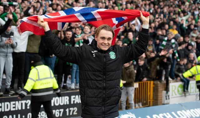 Elias Melkersen with a Norwegian flag as he celebrates with the Hibs fans at the end of the game