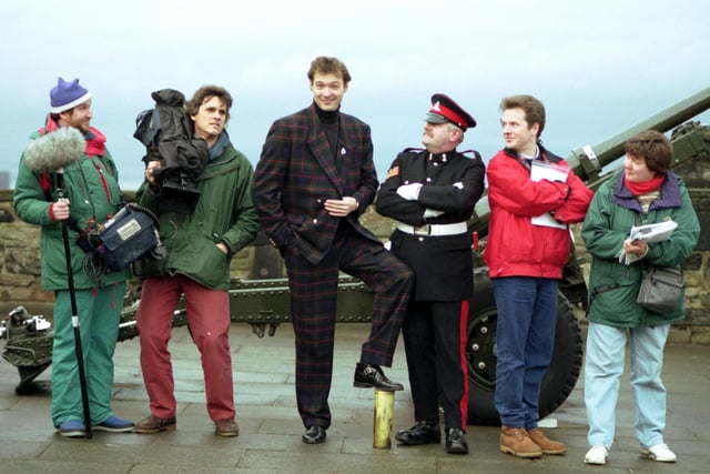 Blue Peter presenter John Leslie came home to Edinburgh with his film crew, pictured with Sergeant Tam McKay ('Tam the Gun') at Edinburgh Castle in December 1992.