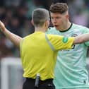 Kevin Nisbet argues with the referee Craig Napier on a frustrating day for the Hibs striker