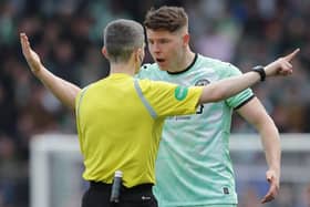 Kevin Nisbet argues with the referee Craig Napier on a frustrating day for the Hibs striker