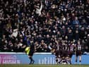 The Hearts players celebrate in front of a jubilant away support after Toby Sibbick put them 3-0 ahead. Picture: SNS