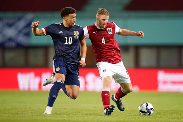 Che Adams (left), pictured battling for possession with Austria's Martin Hinteregger on Tuesday night, has staked a firm claim to be Scotland's first choice striker. (Photo by Christian Hofer/Getty Images)