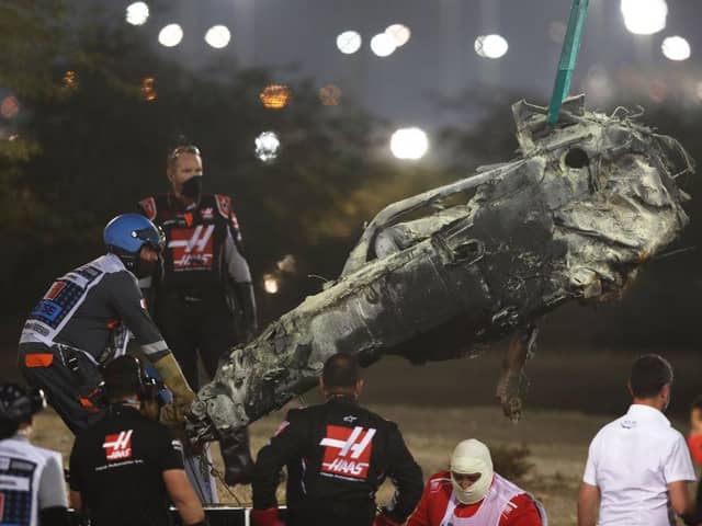 Track marshals clear the debris following the crash of Romain Grosjean of France and Haas F1 during the F1 Grand Prix of Bahrain at Bahrain International Circuit on November 29, 2020 in Bahrain, Bahrain. (Photo by Tolga Bozoglu - Pool/Getty Images)