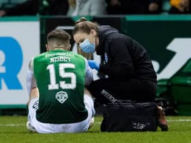 Hibs physio Alix Ronaldson treats Kevin Nisbet for an injury