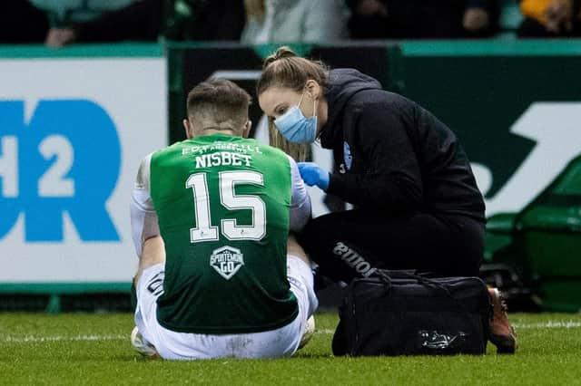 Hibs physio Alix Ronaldson treats Kevin Nisbet for an injury