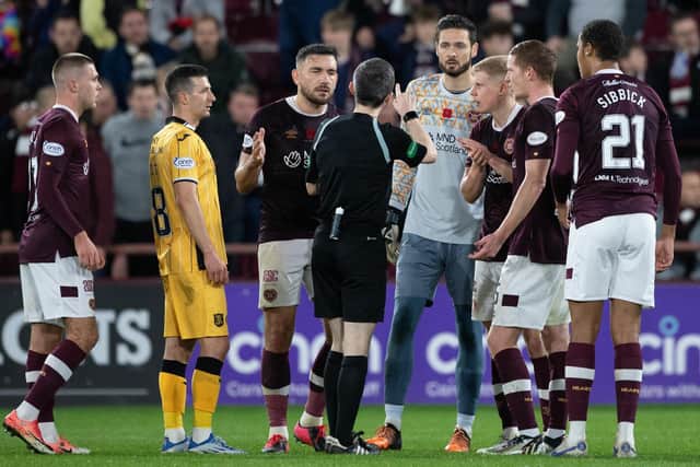 Toby Sibbick joins a scrum of Hearts players arguing with referee Craig Napier during Saturday's controversial encounter at Tynecastle. Picture: SNS