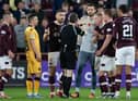 Toby Sibbick joins a scrum of Hearts players arguing with referee Craig Napier during Saturday's controversial encounter at Tynecastle. Picture: SNS