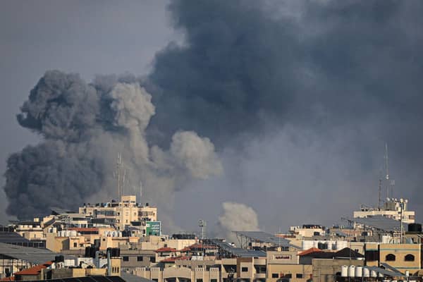 Smoke billows during Israeli strikes on Gaza City yesterday. Israel said it recaptured Gaza border areas from Hamas as the war's death toll passed 3,000 (Photo by IBRAHIM HAMS/AFP via Getty Images)