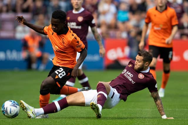Grant slides into Dundee United's Mathew Cudjoe. Picture: Mark Scates / SNS