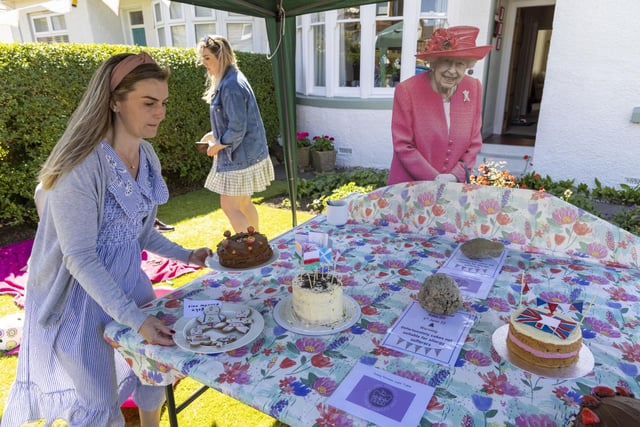 Residents of Netherby Drive in Trinity celebrate with some with home-backed delights. (Photo by Robert Perry/Getty Images)