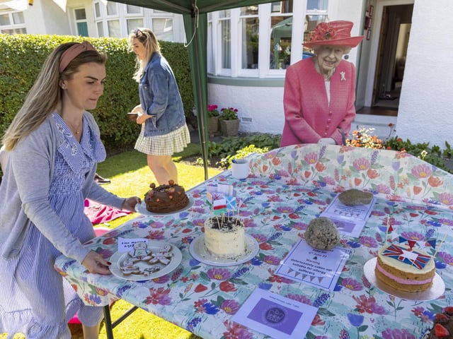 Residents of Netherby Drive in Trinity celebrate with some with home-backed delights. (Photo by Robert Perry/Getty Images)