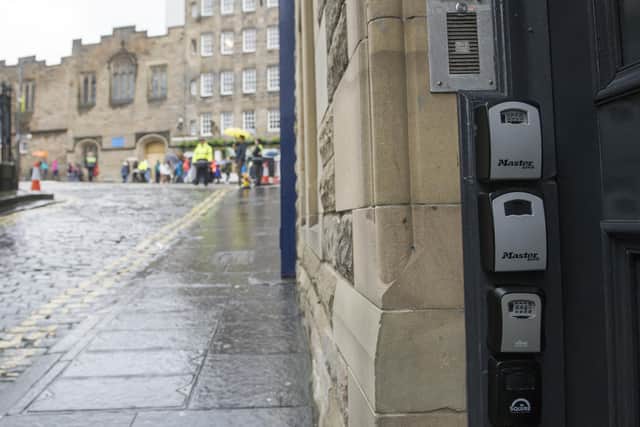 Key boxes for Airbnb properties outside a tenement flat in Upper Bow, Edinburgh. Picture Ian Rutherford