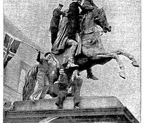 Exuberant Army, Navy and RAF revellers "mount" the Wellington equestrian statue outside Register House on VE Day.