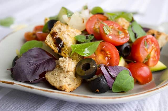 Vegan salad with tomatoes and black olives.
