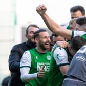 Hibs defender Ryan Porteous is mobbed by his team-mates after scoring the winning penalty.
