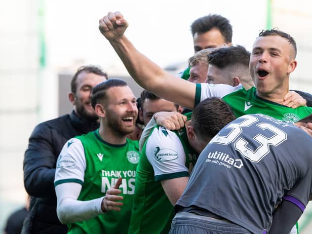 Hibs defender Ryan Porteous is mobbed by his team-mates after scoring the winning penalty.