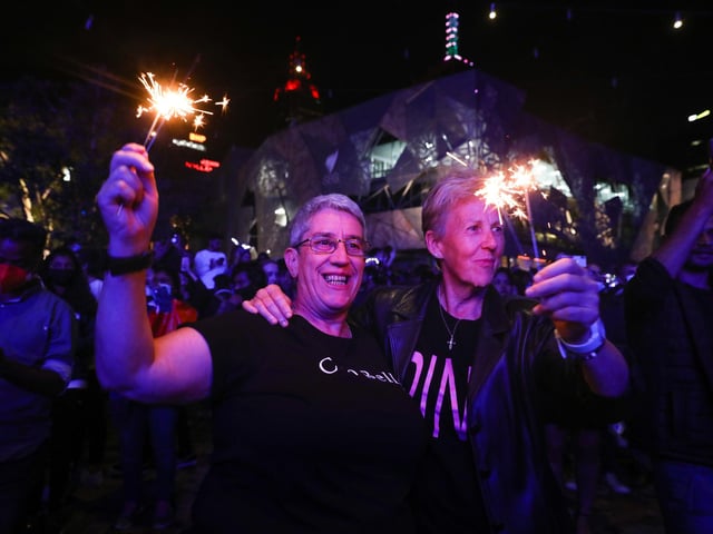 People with sparklers lit up celebrate the New Year at Federation Square during New Year's Eve celebrations on January 1, 2021 in Melbourne, Australia. Celebrations look different this year as COVID-19 restrictions remain in place due to the ongoing coronavirus pandemic.