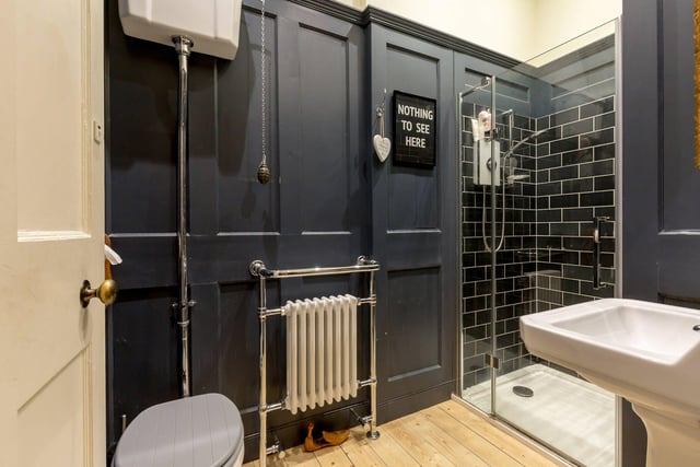 A spacious entrance hall gives access to all rooms and contains three useful store cupboards as well as a contemporary shower room, pictured above, and a useful utility room with washing machine, tumble dryer and freezer.