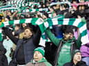 Hibs fans sing 'Sunshine on Leith' in tribute to late chairman Ron Gordon before the match against Rangers at Easter Road