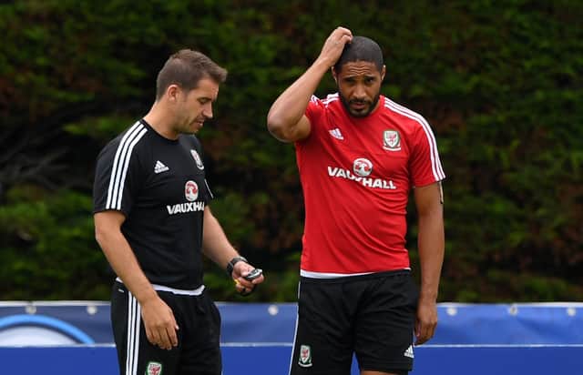 Adam Owen speaks with Wales captain Ashley Williams during Euro 2016