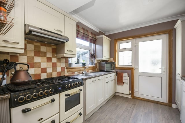 The large kitchen is fitted with appliances and offers plenty of storage.