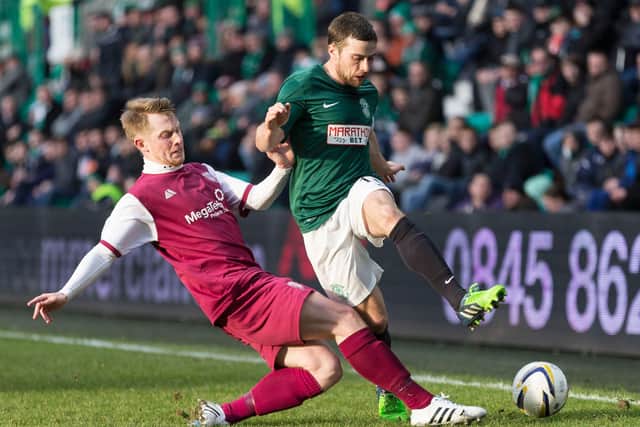 Stevenson in action against Liam Rowan of Arbroath in a 2014/15 Scottish Cup tie at Easter Road