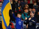 A young Scotland fan waves a Ukrainian flag during a friendly match against Poland at Hampden Park in March (Picture: Andrew Milligan/PA)