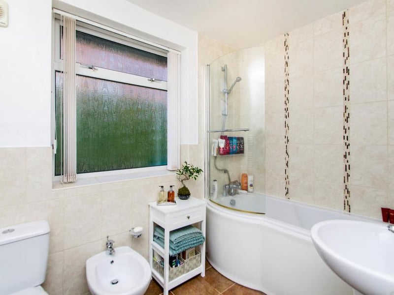 The versatile bathroom boasts all you need. A low-flush WC, wash basin, panelled bath with shower over, bidet, radiator and double-glazed window to the side.