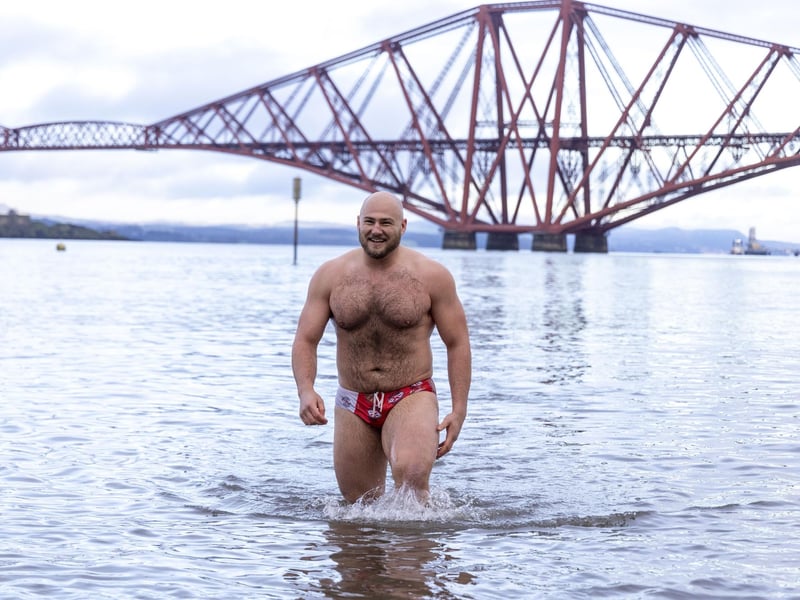 One swimmer enjoys his Daniel Craig moment as he emerges from the waves