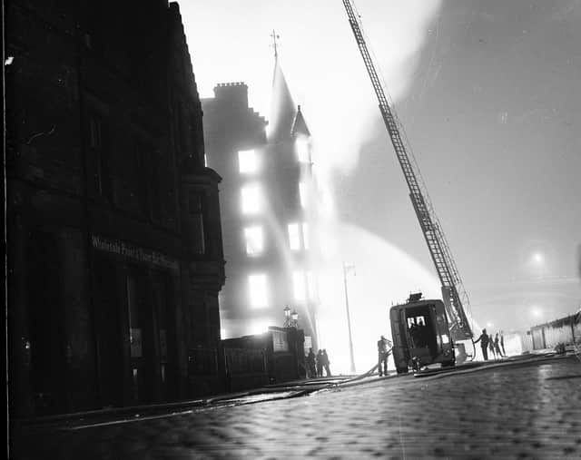 In 1955 two spectacular fires took places in Edinburgh within 24 hours of each other. First a fire at C W Carr warehouse and James Aitman show factory in Jeffrey Street.  Fire engine and extended ladder pictured at the scene.